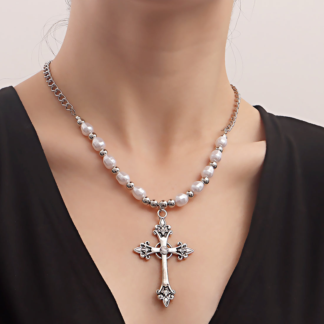 Pearl necklace paired with a cross pendant necklace, vintage-style cross necklace for women