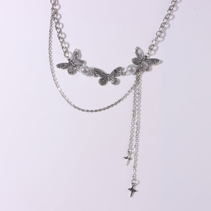 Butterfly necklace with luminous pearls and star tassel pendant