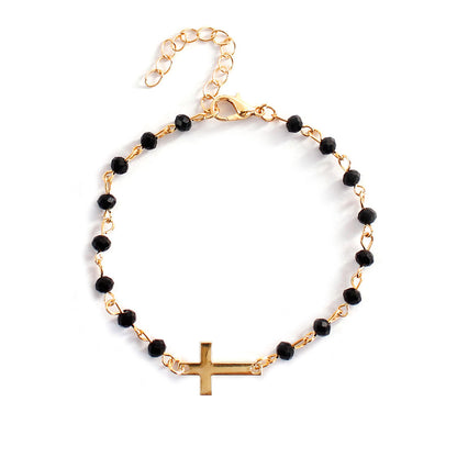 Delicate cross bracelet featuring an obsidian beads with gold-plated cross